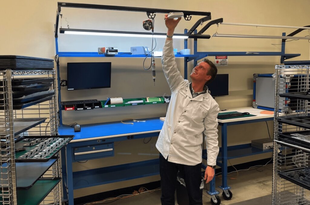 Garrett Bastable, Head of Operations at Density, holds a Density people counting device in his factory in Syracuse, NY